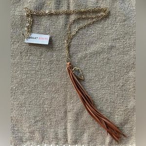 Gold chain with brown leather tassel necklace with stone lined with gold foil.